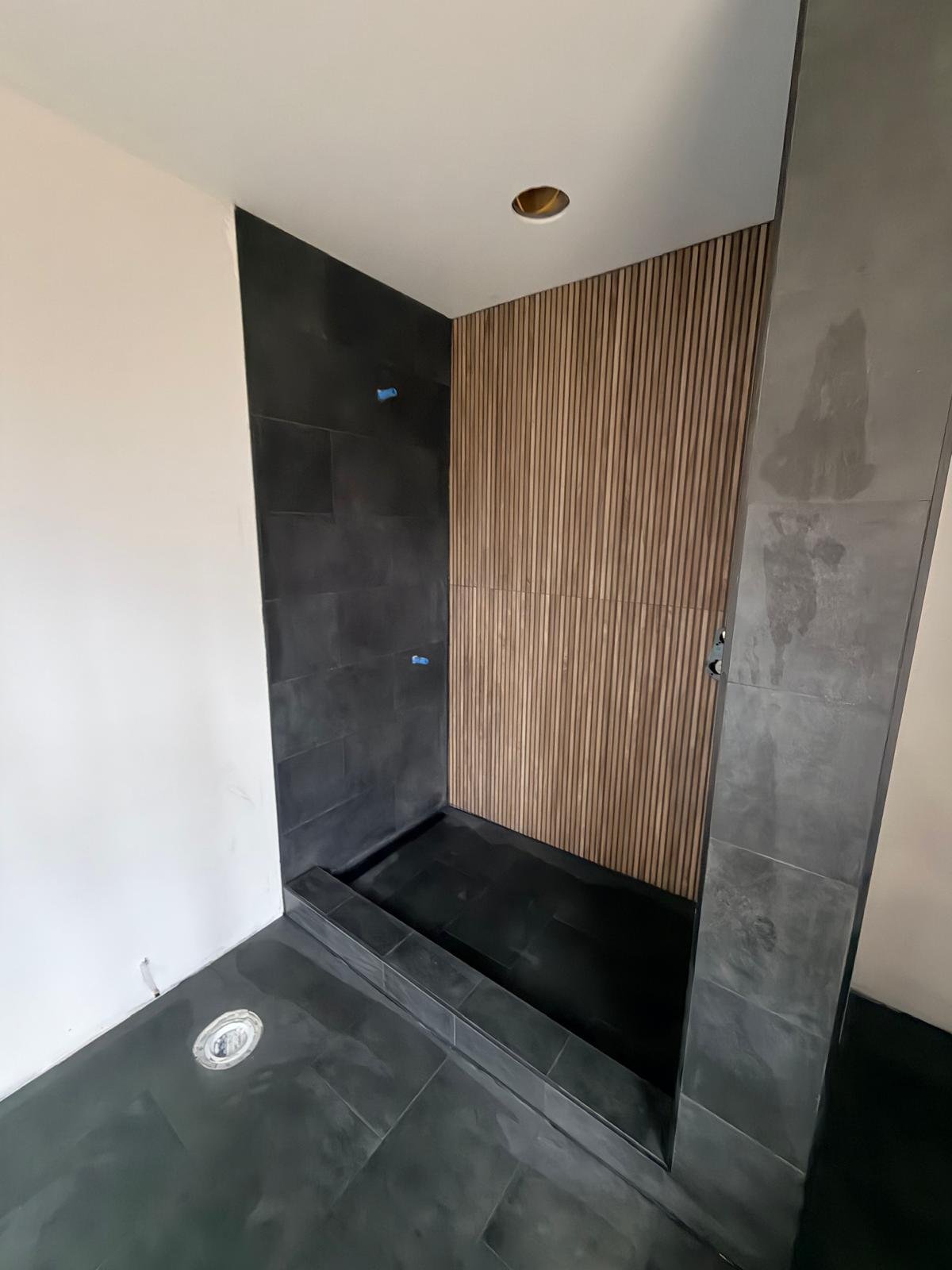 Shower with wood-look slat wall and graphite porcelain