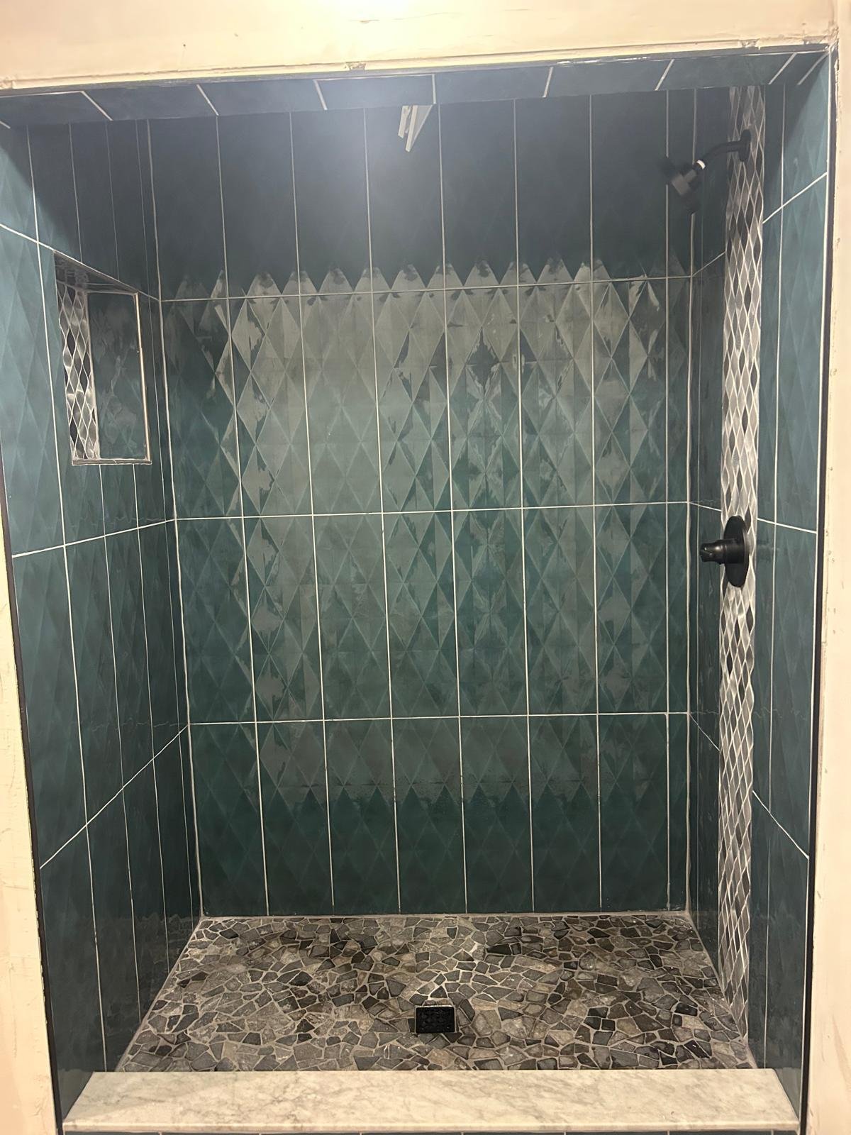 Green tile shower with niche