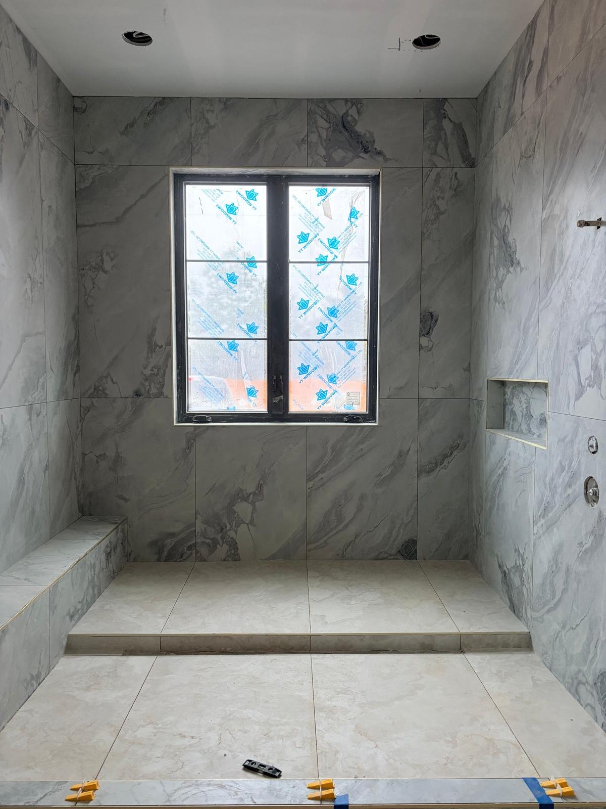 Marble-look bathroom with built-in bench