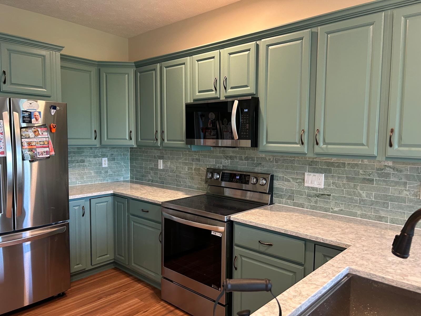 Kitchen with green tile backsplash