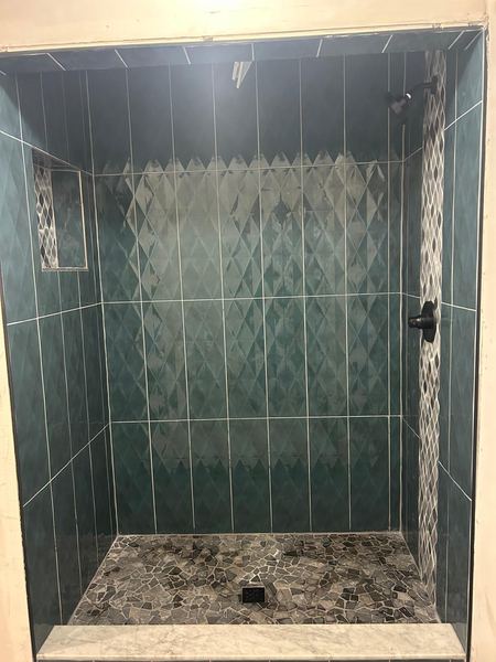 Green tile shower with niche
